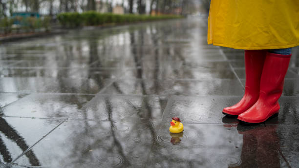 istock Yellow rubber duck in the puddle 1395930130