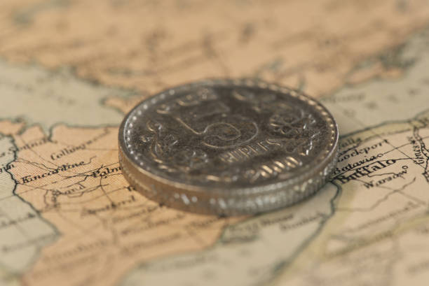 istock Five rupee steel coin on top of a map. 1395931265
