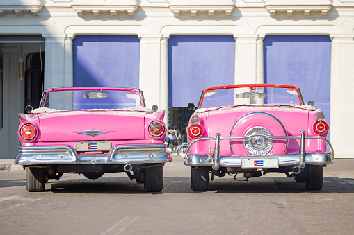 Pink taxi convertible vintage car in old Havana Cuba left car Ford Fairlane 1957