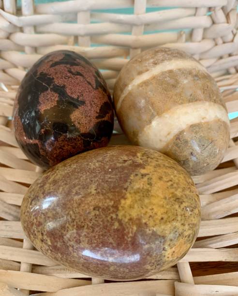istock Three carved stone eggs in a white wicker basket 1395931457