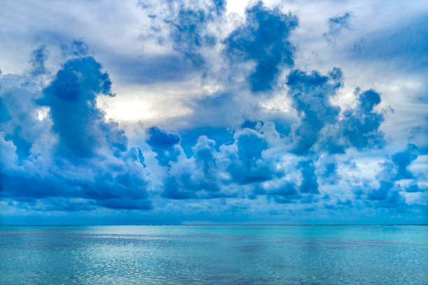 Rain Storm Coming Cloudscape Outer Reef Blue Water Moorea Tahiti French Polynesia. Different blue colors in water in  lagoon and coral reefs