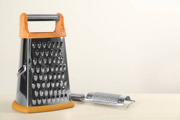 istock Modern graters on white wooden table. Space for text 1395932830