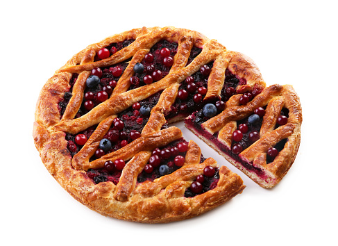 Delicious cut currant pie and fresh berries on white background