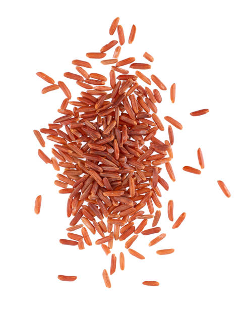istock Red rice isolated on white background. Whole grain raw brown rice. Top view. 1395934657