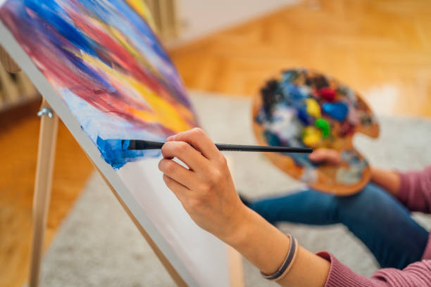 istock Female artist painting 1395936477
