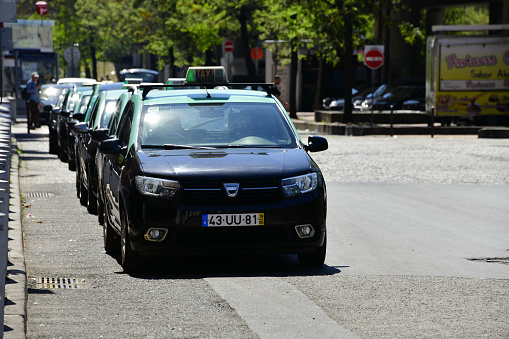 Lisbon, Portugal: line if Lisbon taxis wait at a stand on Lusiada Avenue - Portuguese taxis