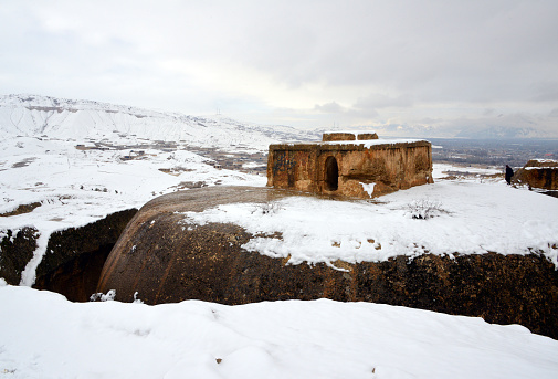 Takht-e Rustam, Aybak, Samangan Province, Afghanistan: Takht-e Rustam, Persian for 'Rustam's throne', a Buddhist stupa cut into a mountain top, like the monolithic churches of Ethiopia, part of a stupa-monastery dating from the Kushano-Sasanian period 4th-5th century AD - the square building atop the stupa is the 'Harmika', it once held relics of the Buddha. The circular corridor was used by pilgrims for circumambulation. Afghan Lalibela.