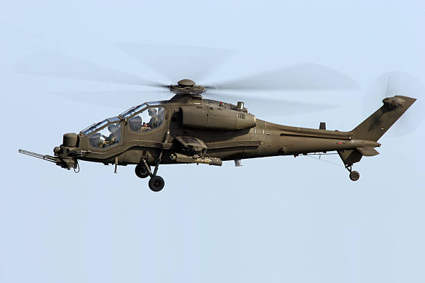 istock Armed military helicopter isolated against clear blue sky 139593951
