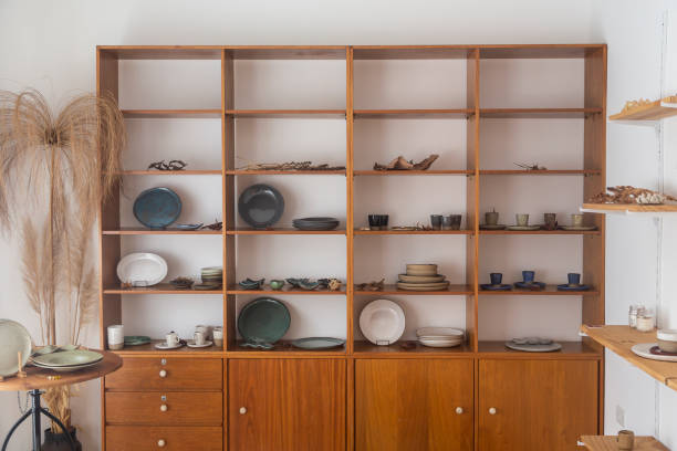 istock Wooden shelf with ceramic pieces in various styles 1395940103