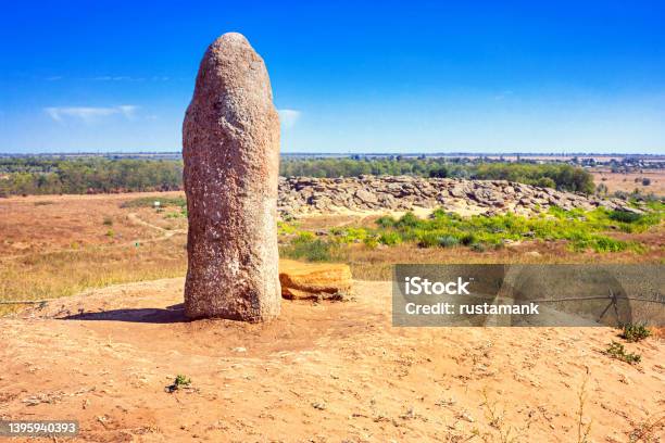 View Of The Ancient Kurgan Stela Stone Idol Against The Backdrop Of Kamyana Mohylain Is An Archaeological Site Ukraine Stock Photo - Download Image Now