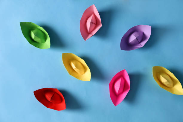 istock Colorful paper boats on light blue background, flat lay. Diversity concept 1395940604