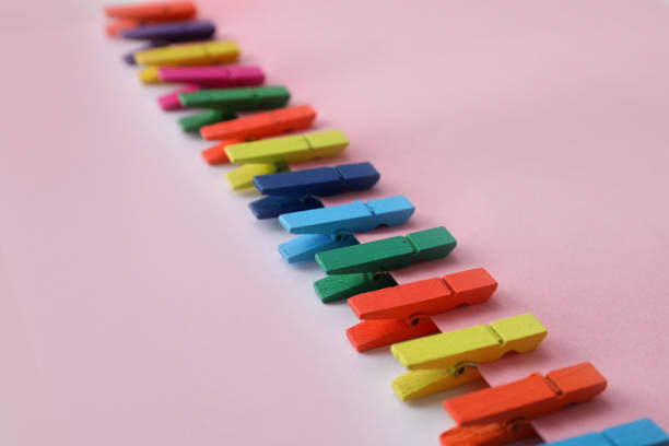 istock Many different colorful clothespins on pink background. Diversity concept 1395940617