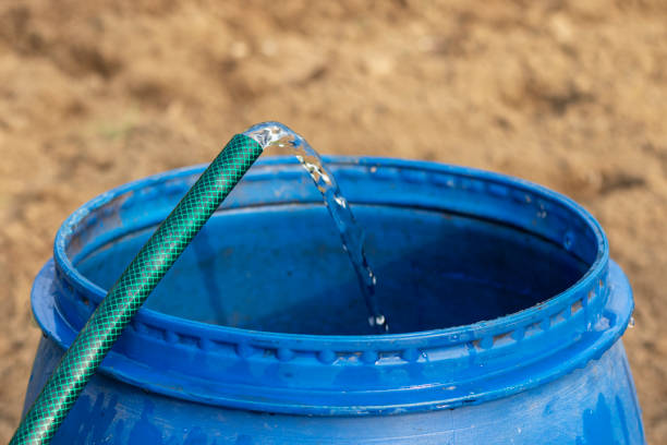 Barrel of water filled upto its top surface from rain water from roof. Rain water harvesting or conservation concept