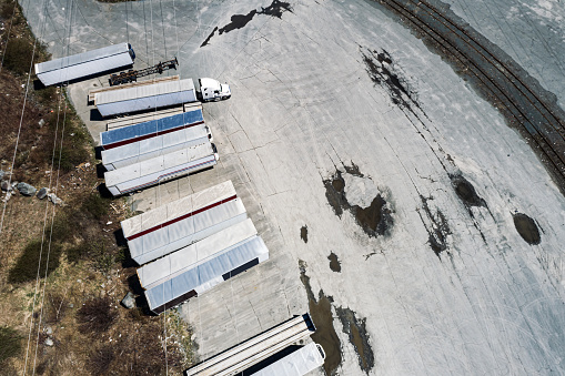 Trailers await pickup from a trucking yard.