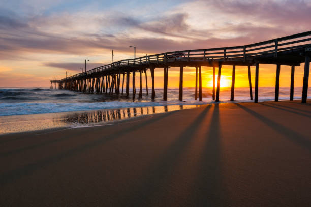istock Morning sunlight filtering through beach fishing pier 1395945353