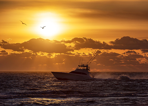 A fishing vessel heading out to sea from the Oregon Inlet along the Outer Banks of North Carolina