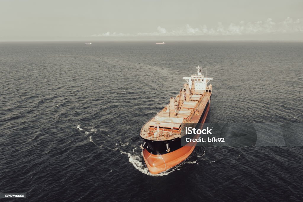 Aerial view of cargo ship in transit. Aerial view of cargo ship entering to an international port. Ship Stock Photo
