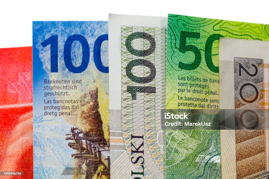 Swiss franc and Polish zloty in cash, PLN and CHF Swiss and Polish money. Banknotes of the Polish zloty and Swiss franc were placed next to each other and are now the backdrop to many different financial matters. PLN and CHF currencies Swiss Currency Stock Photo