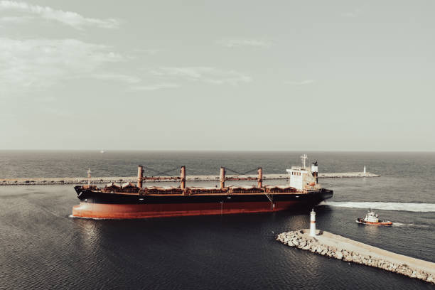 Aerial view of cargo ship entering to an international port.