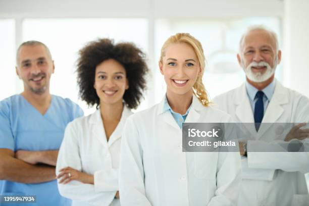 Group Of Dentists Looking At Camera Stock Photo - Download Image Now - Dentist, Group Of People, Teamwork
