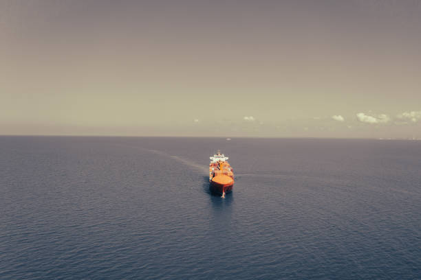 Aerial view of Container freight ship carrying container box for import and export business logistic and transportation by container ship in open sea. Approaching to Mersin international port.