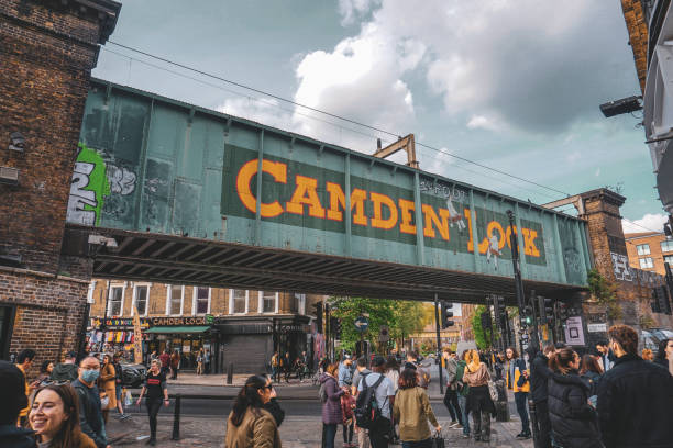 Busy Camden Town High street with iconic railway bridge Camden town's famous market in North London camden market stock pictures, royalty-free photos & images