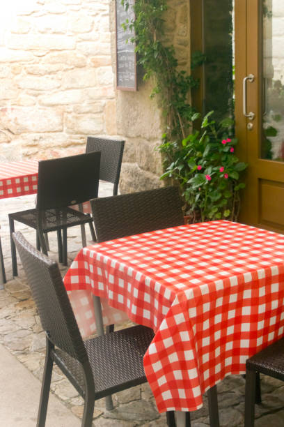 istock Sidewalk cafe, restaurant. Checkered red tablecloth. 1395949468