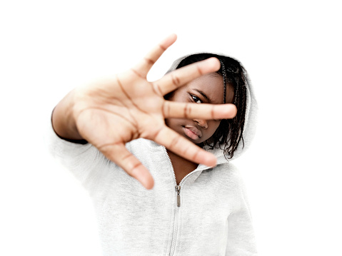Rebel preteenage girl wearing a gray hooded sweatshirt, 12 years old, isolated (cut out), white background