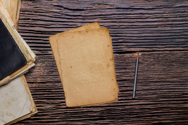 istock vintage paper sheets and old notebooks on wooden background 1395952516