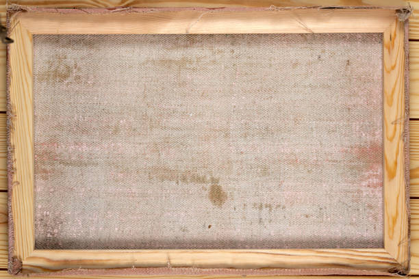 Back of old canvas in wooden frame as abstract background.