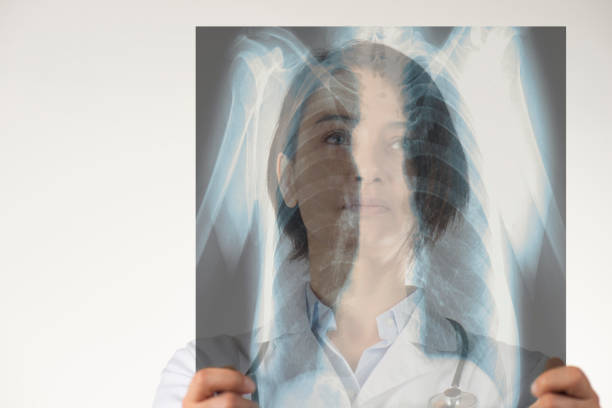 Female doctor is looking at x-ray of skeleton.