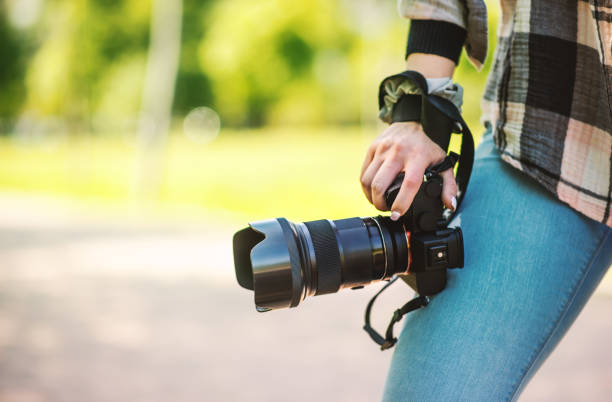 istock Freelance female photographer holding a camera. Creative occupation concept 1395956571