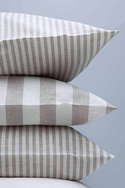 White and beige lined pillows in close-up stock photo