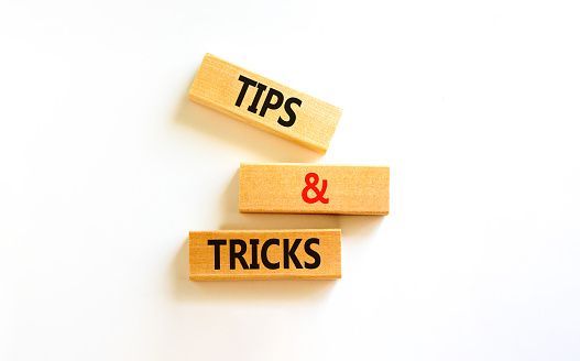Tips and tricks symbol. Concept words Tips and tricks on wooden blocks. Beautiful white table, white background. Business, tips and tricks concept. Copy space.