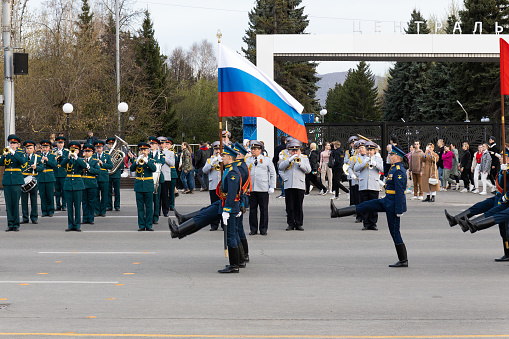 Krasnoyarsk, Russia - May 5, 2022: Soldiers in full dress march solemnly carry the Russian national flag during the rehearsal of the Victory Military Parade in the Great Patriotic War