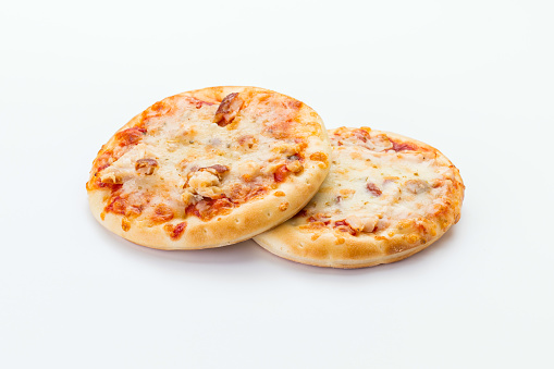 Two Italian mini pizzas on a white background