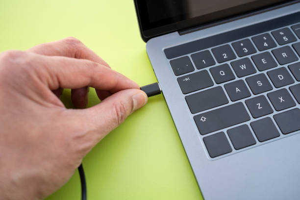 istock man connecting a usb-c cable on a laptop 1395959220