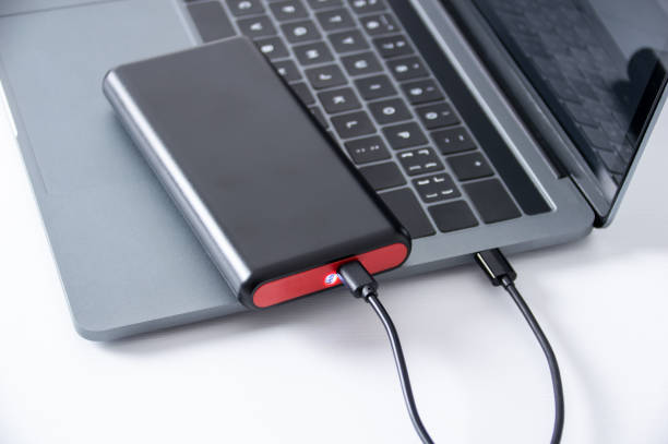 istock laptop charging with a power bank drive 1395959228
