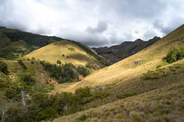 istock Mountain valley illuminated by sunbeams on a cloudy day, Chile 1395962778