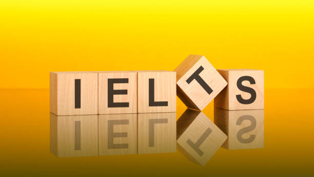 istock IELTS - text of on wooden cubes, reflected from the bright yellow surface 1395963539