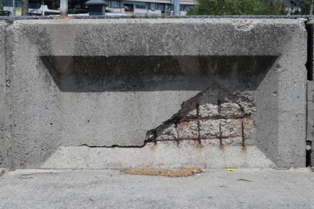 Concrete wall decays and exposes the rusting steel beams below. Concrete element crumbles_1