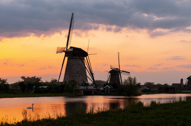 istock Sunset on traditional Dutch windmills, at Kinderdijk 1395968360