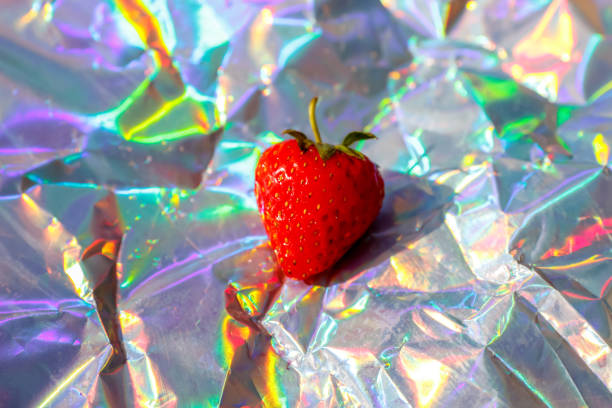 Defocus close-up one ripe red strawberry on modern hologram background. Fruits and berries. Harvest and crop concept. Organic. Trendy gradient. Shiny foil. Out of focus