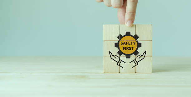 istock Safety first symbols, work safety, caution work hazards, danger surveillance, zero accident concept. Wooden cubes with smart grey background. Employees safety awareness at workplace. Safety banner. 1395979790