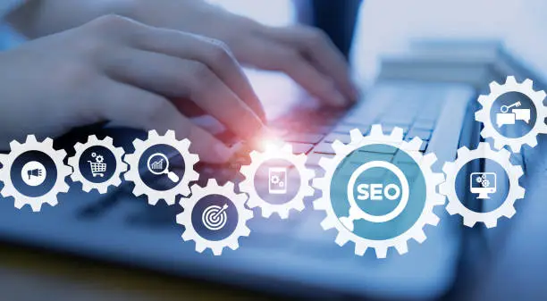 SEO, Search Engine Optimization ranking concept.  Digital marketing strategy of promote traffic to website. Working on computer with the icon of magnifying glass, abbreviation SEO and SEO symbol.