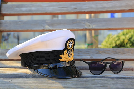 Greek naval officer, admiral, ship white captain cap with sunglasses