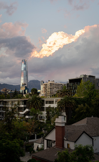 Cloudy sunset over Santiago with buildings and costenera center from the window