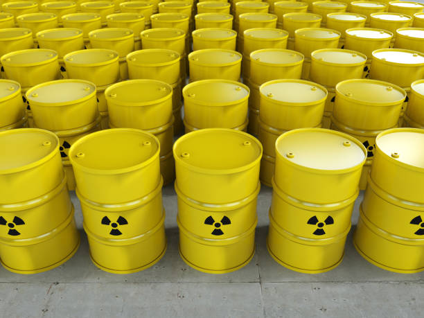 Group of yellow barrels with radiation hazard sign stock photo