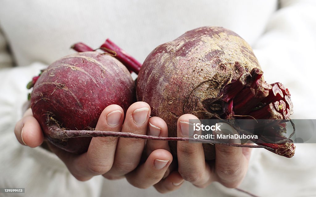 woman holding a beet. woman holding a beet. Concept - Simple Life. Adult Stock Photo