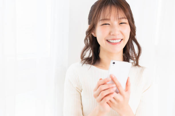 istock attractive Asian woman using a smart phone 1395994349